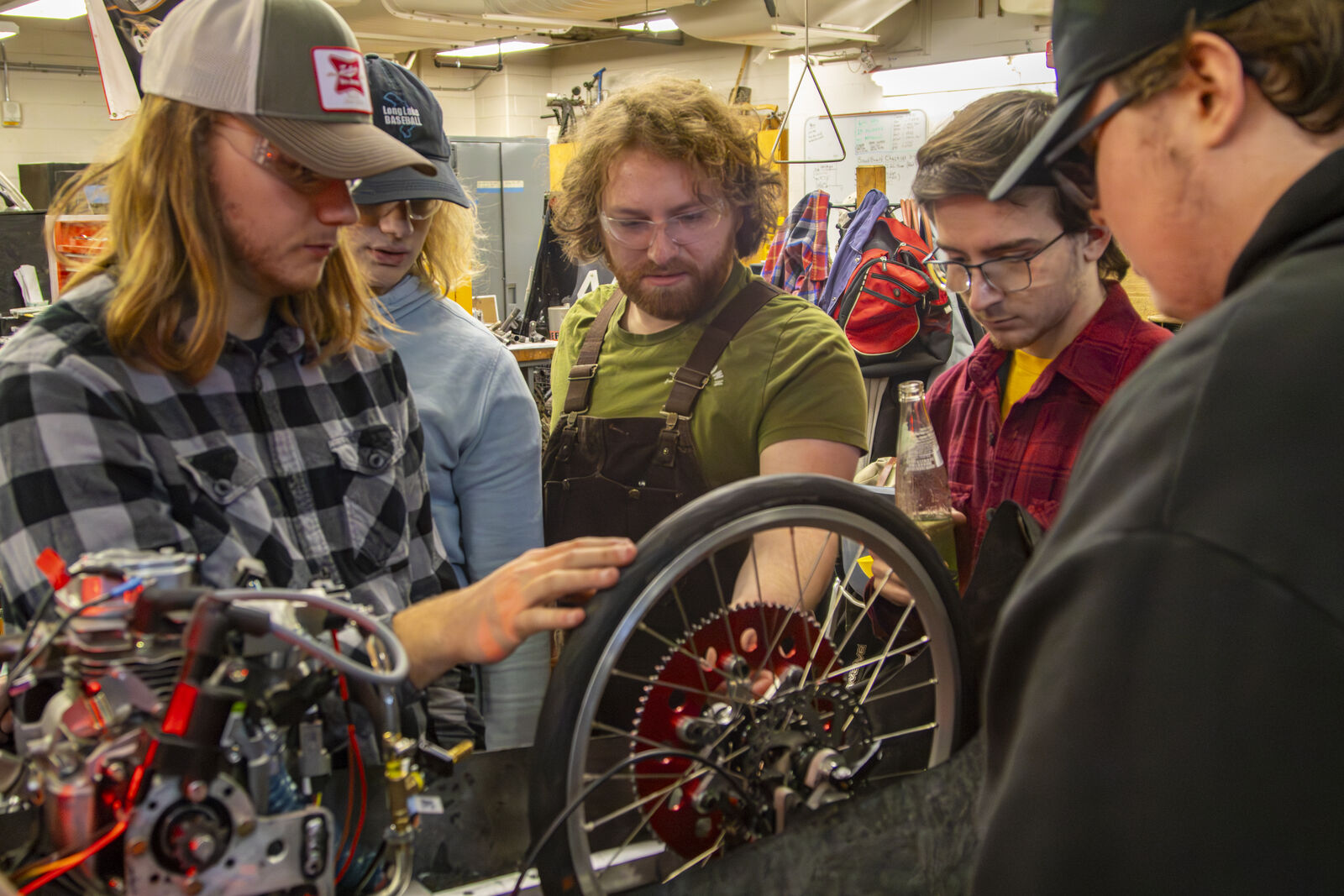 Evan, Carter, Isaac, Alex, and Ty inspecting the rear drivetrain.