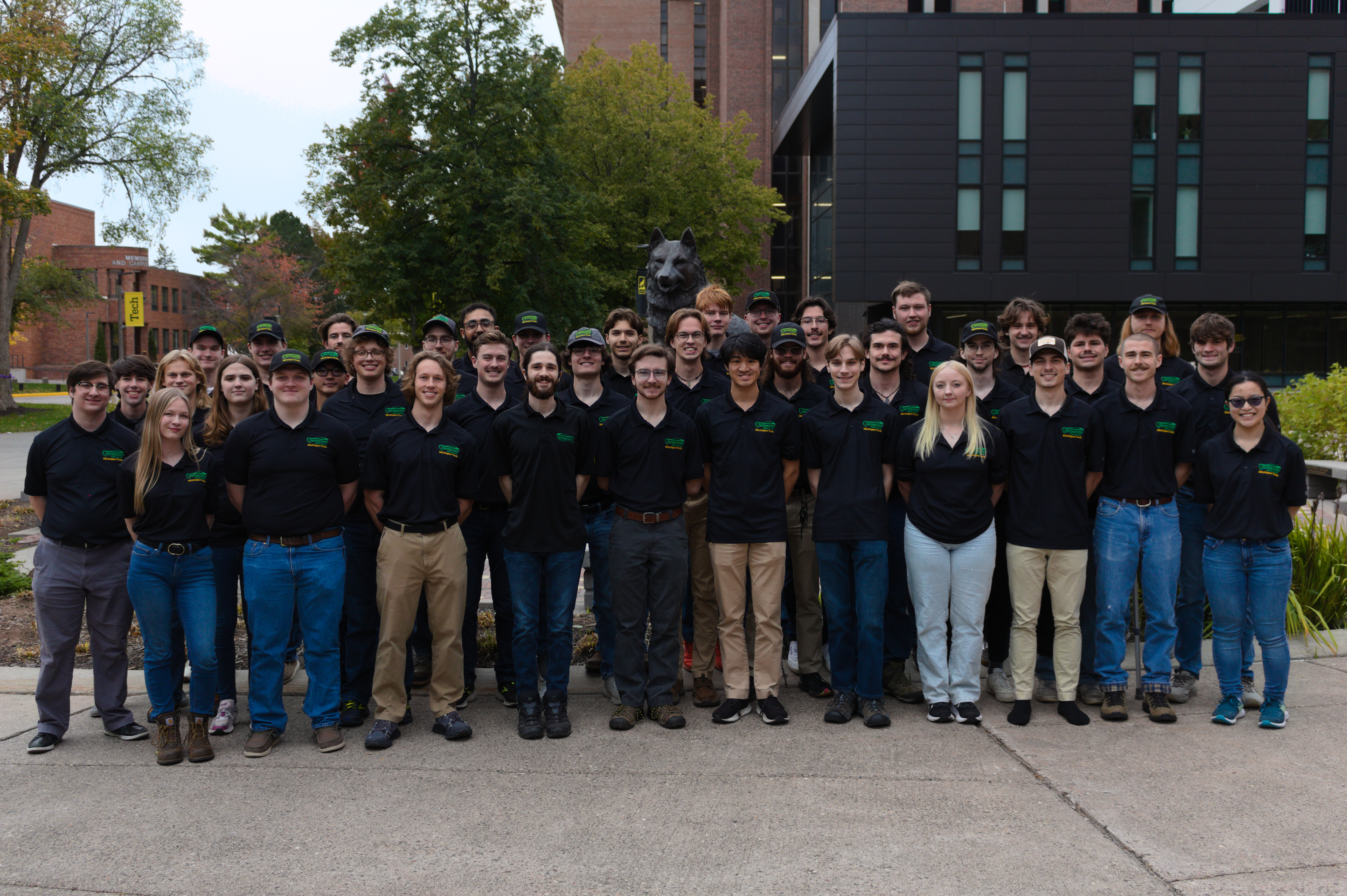 Photo of the Supermileage team in front of the Huskey statue at Michigan Tech